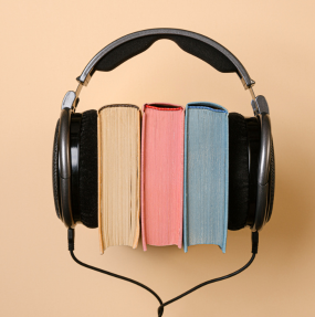 A stack of books wearing headphones